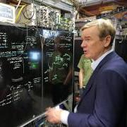 Sen. Michael Bennet visits with Jun Ye, professor adjoint and fellow, while visiting JILA 